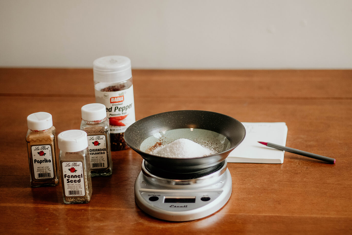 A food scale measuring a variety of seasonings.