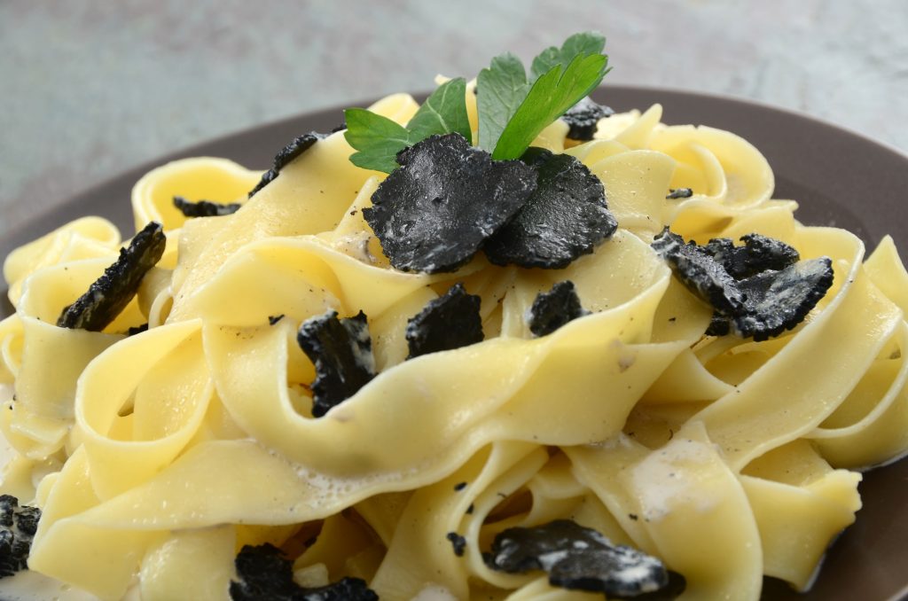 Fresh pasta topped with sliced black truffle mushrooms.