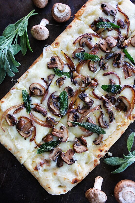A flatbread dressed with sliced mushrooms and sage.