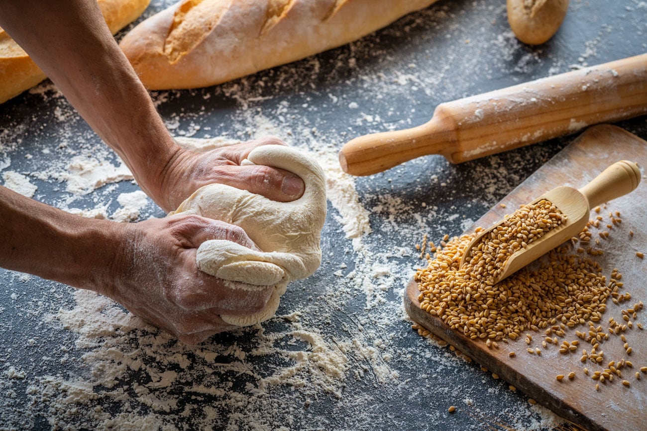 Hands making dough.