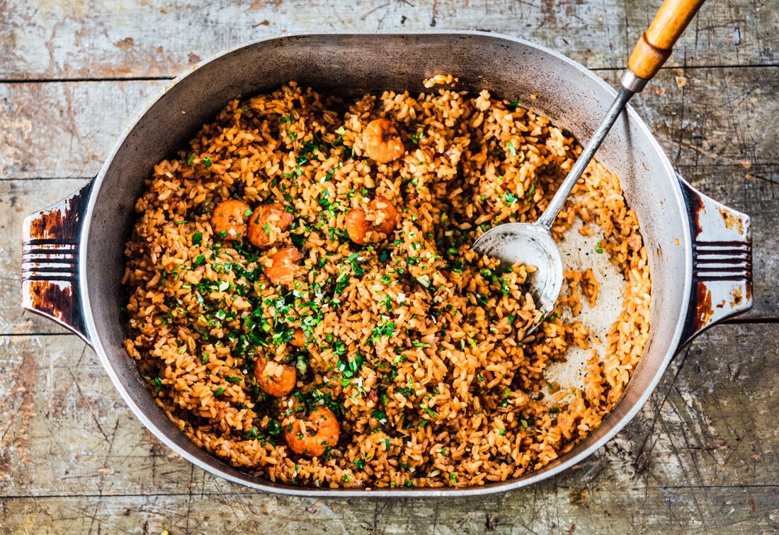 Shrimp jambalaya in a dutch oven with a serving spoon by chef Melissa M. Martin.