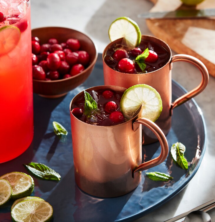 A set of Moscow Mule cocktails in their signature copper mugs.