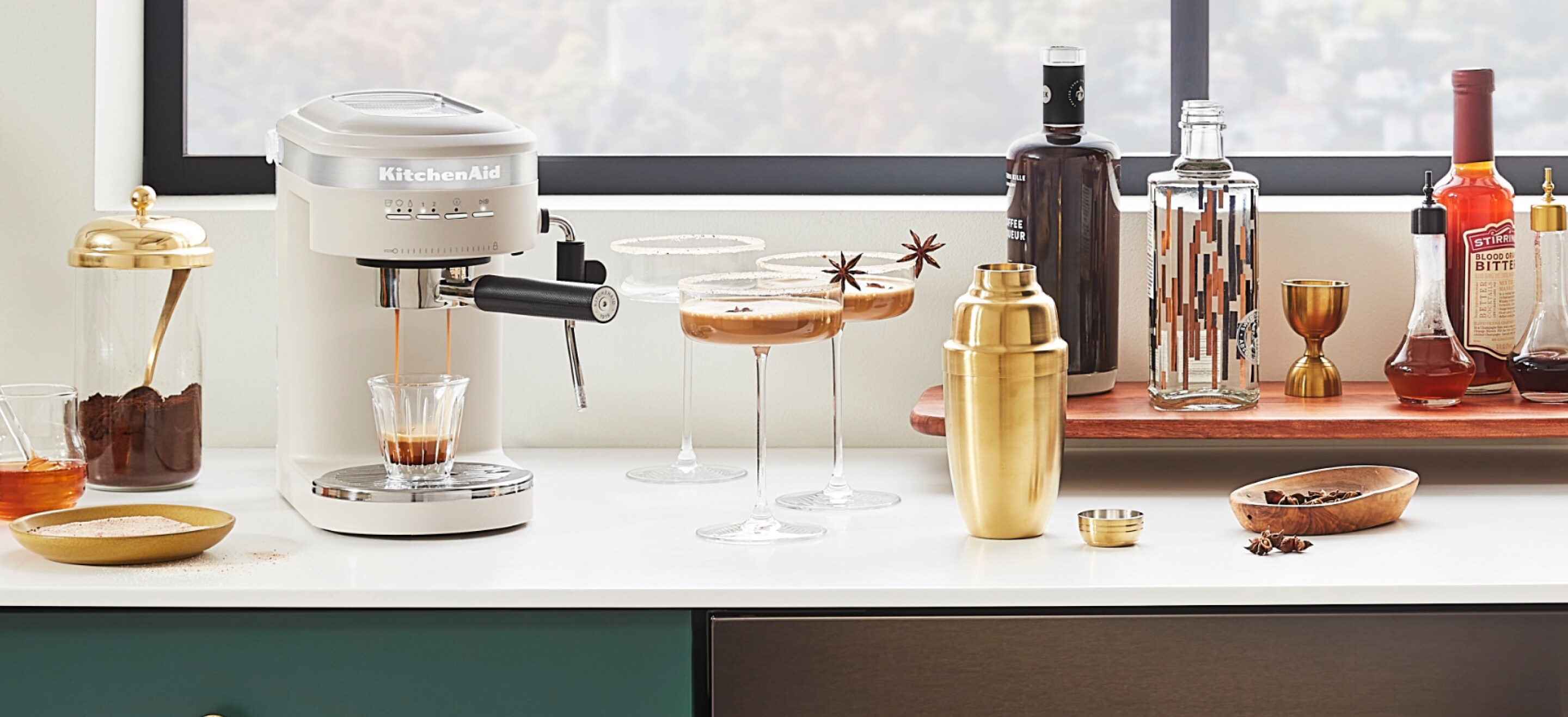 A white KitchenAi® espresso machine on a coffee bar, being used to make espresso martinis.