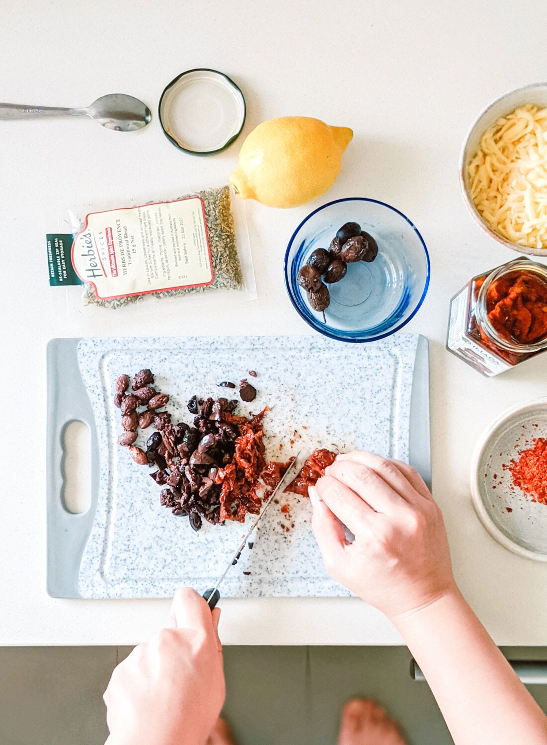 Chopping up ingredients for focaccia bread.