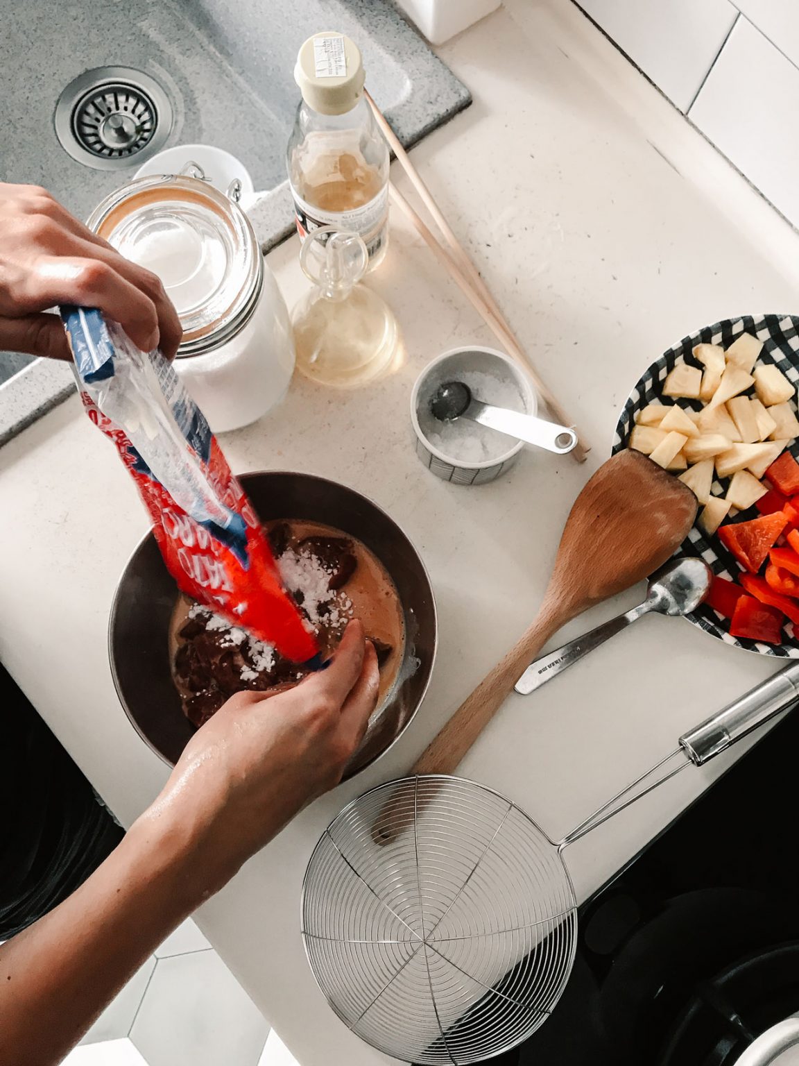 Melly Fong pouring cornstarch into batter.
