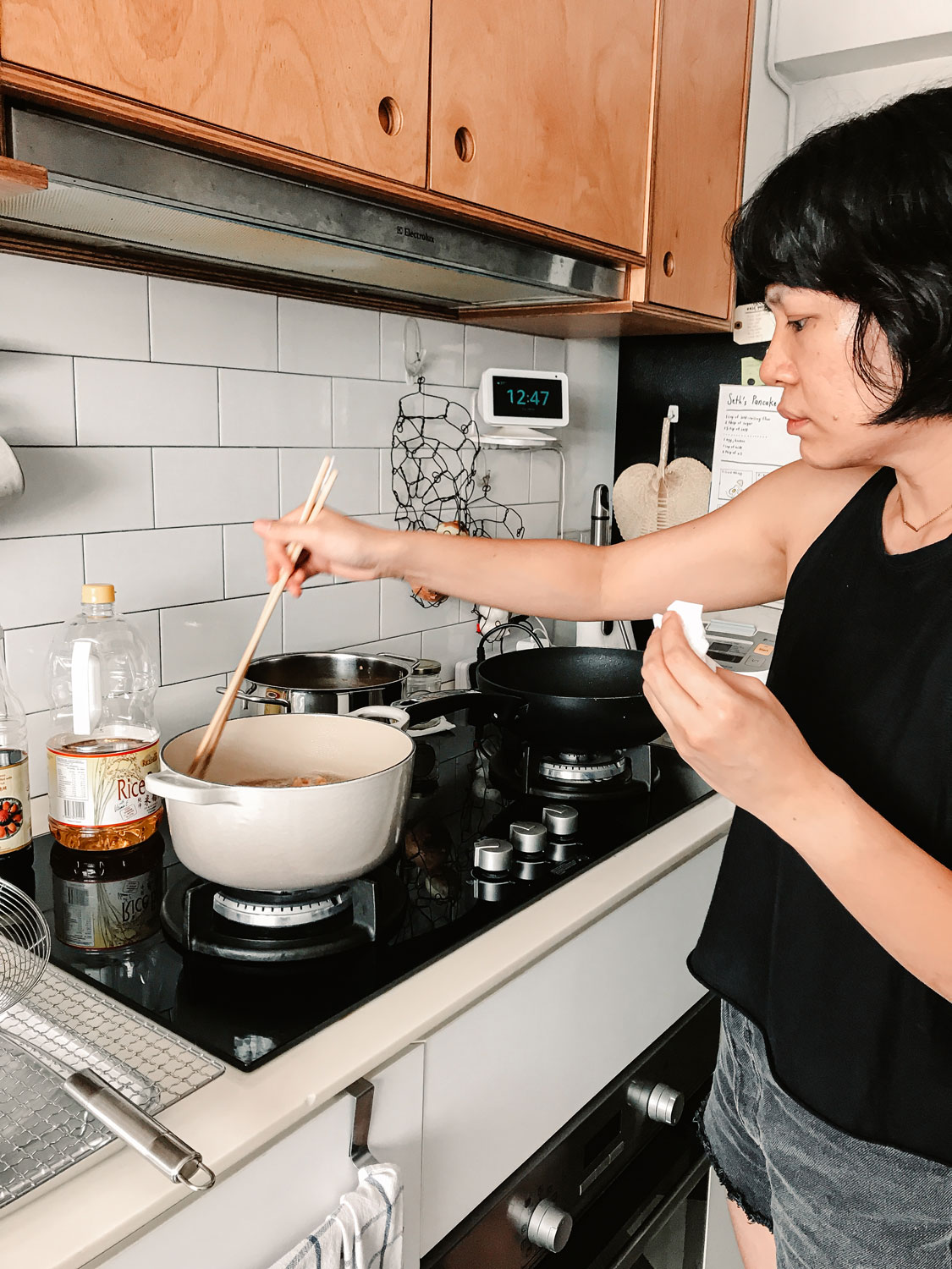 Melly Fong tending to her food cooking on the stove.