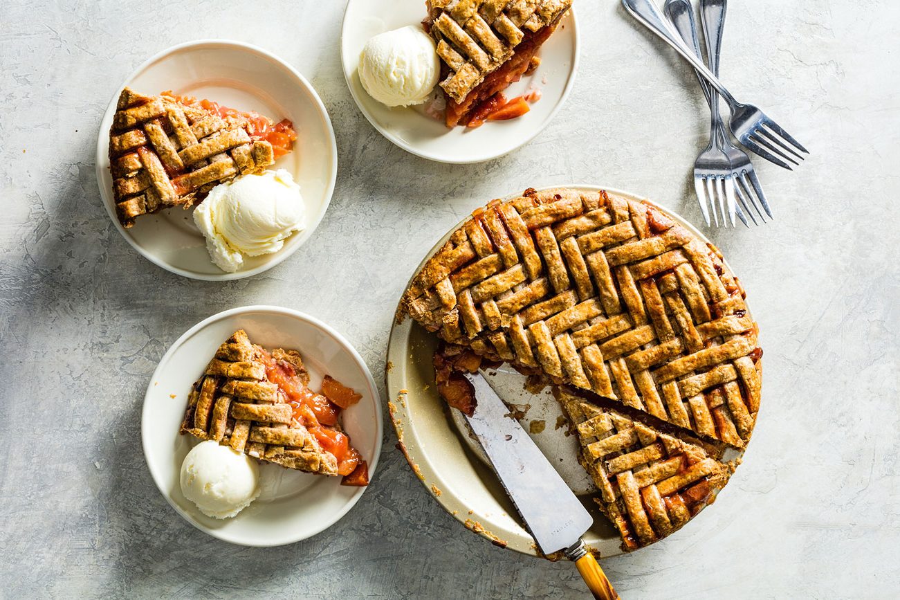 Slices of pie and ice cream ready to be eaten.