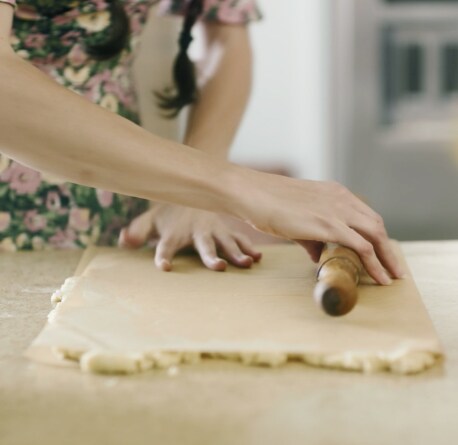 Loria Stern gently rolling out dough.
