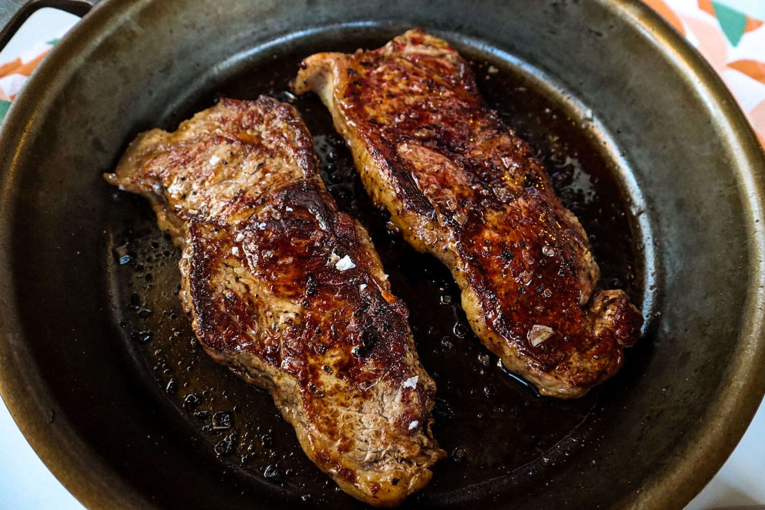 Two slabs of meat sprinkled with salt.