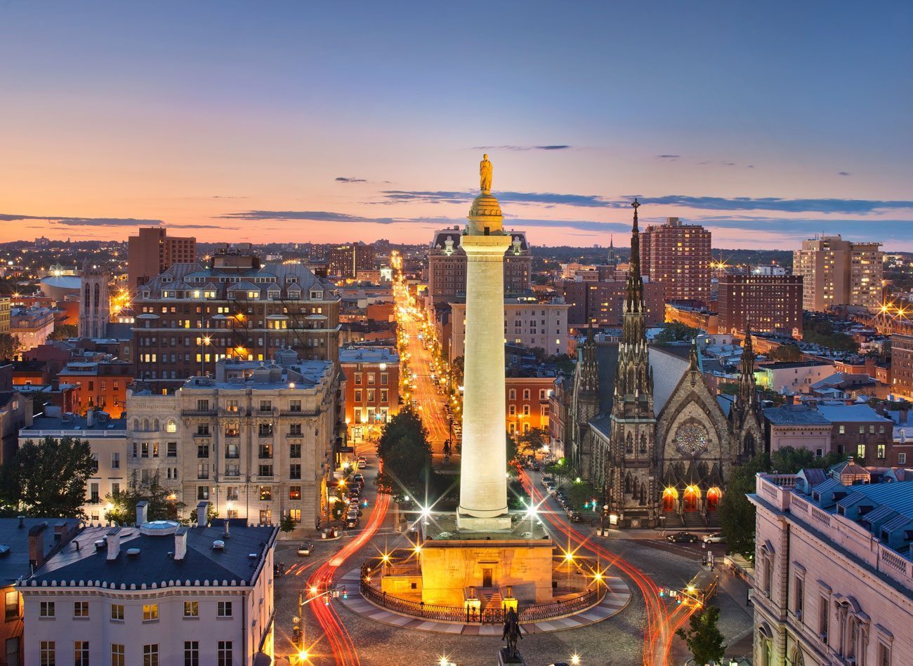 An evening cityscape featuring the Washington Monument.