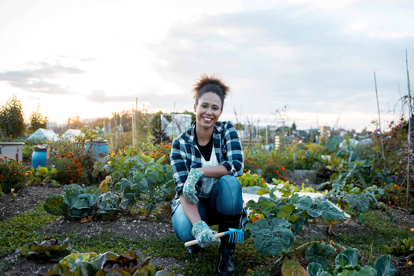 A young woman smiling for the camera in her gardening element.