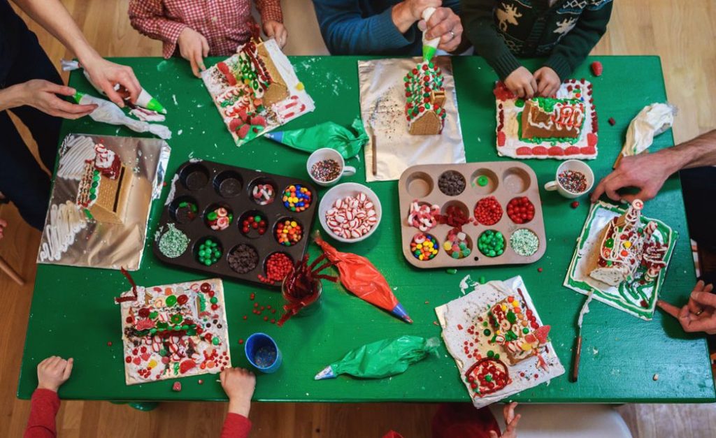 People decorating gingerbread houses.
