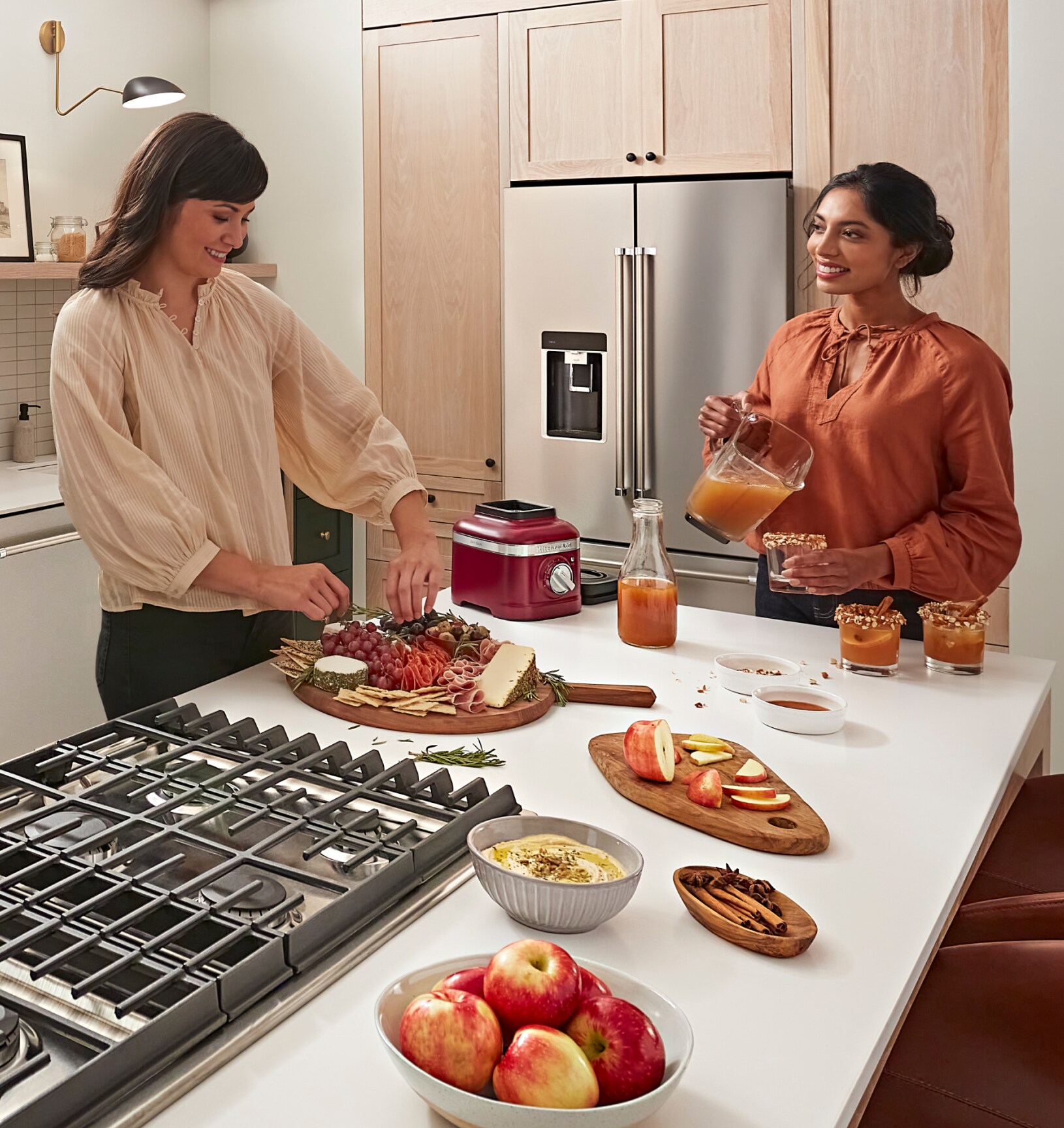 Friends preparing a charcuterie board and pouring drinks