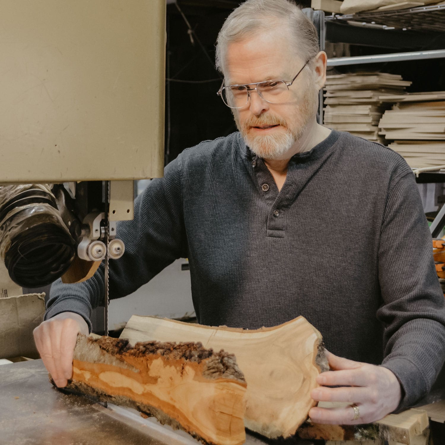 Jonathan Simons holding large pieces of wood.