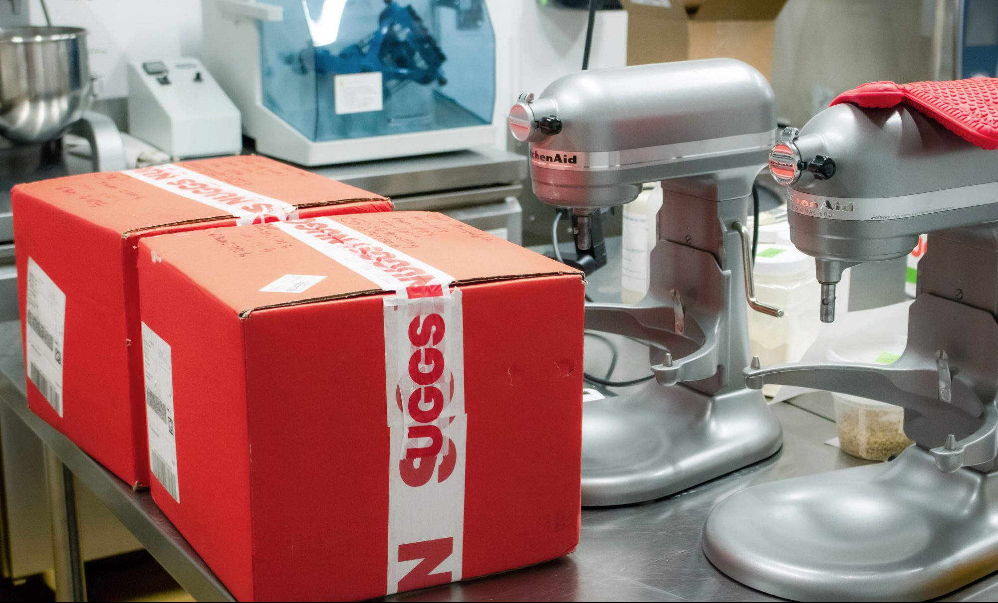 Two red Nuggs boxes tapped up and ready for shipping.