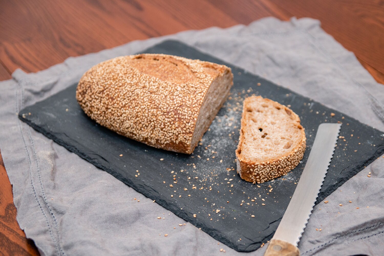 A loaf of bread with single slice cut off.