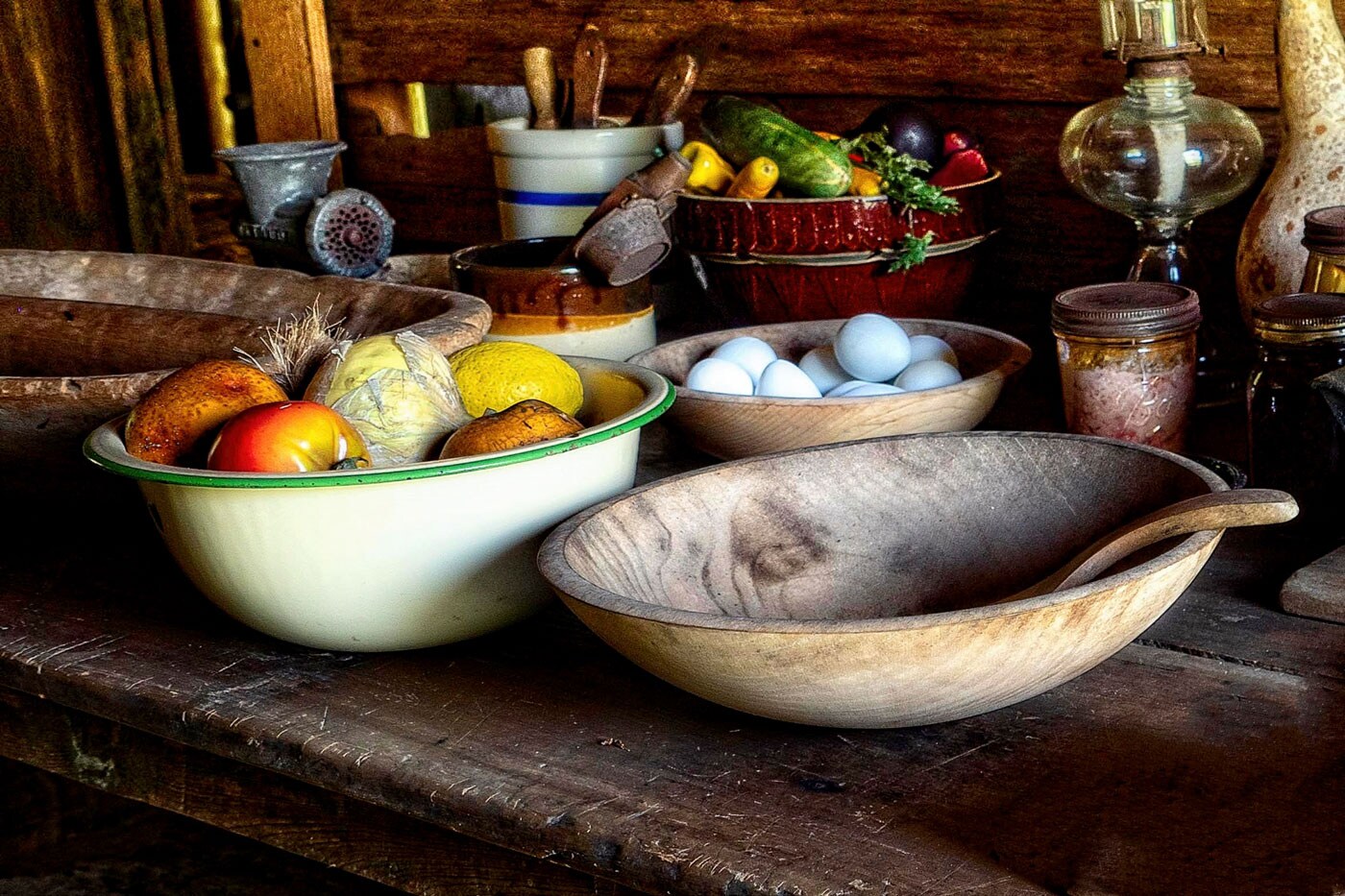 A variety of bowls filled with eggs, vegetables and other items.