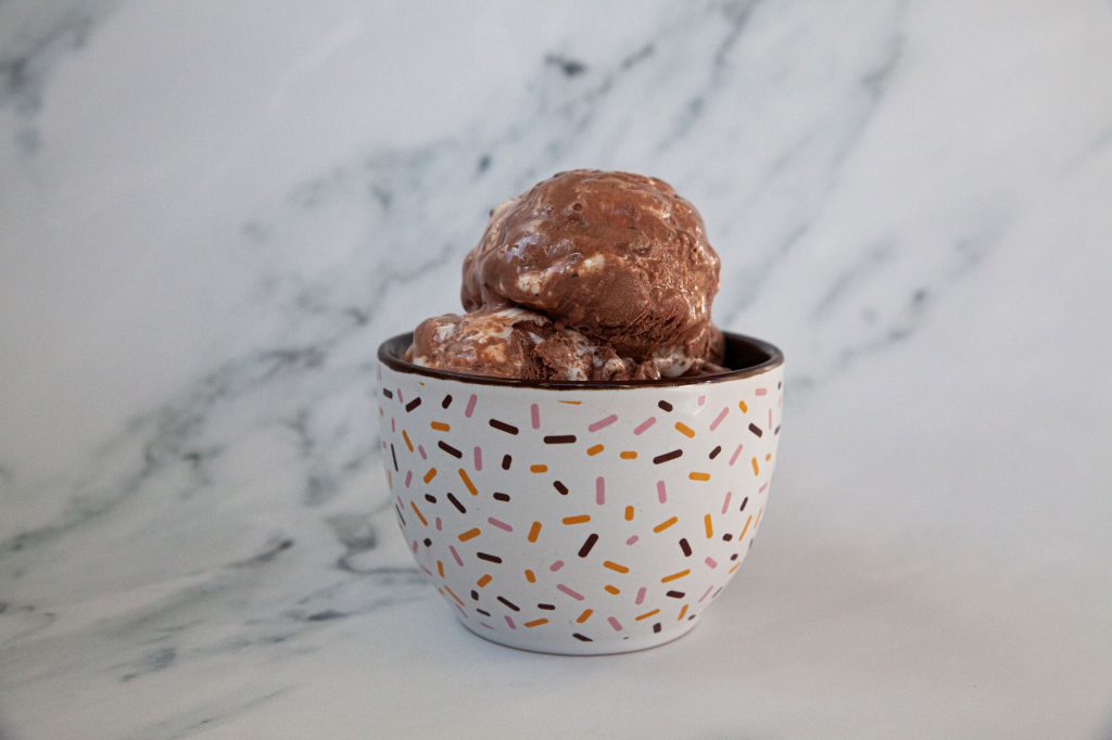 A delicate, coloful bowl filled with ice cream.