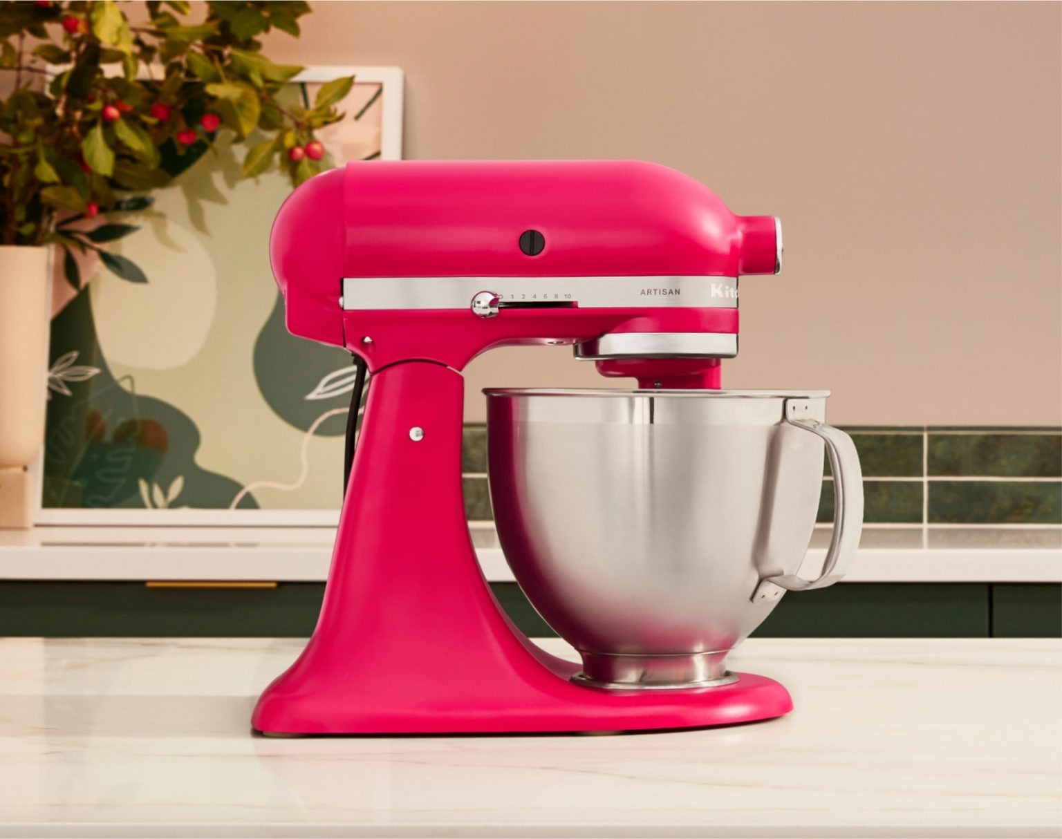  The Artisan® Series Stand Mixer in Hibiscus on a countertop. 