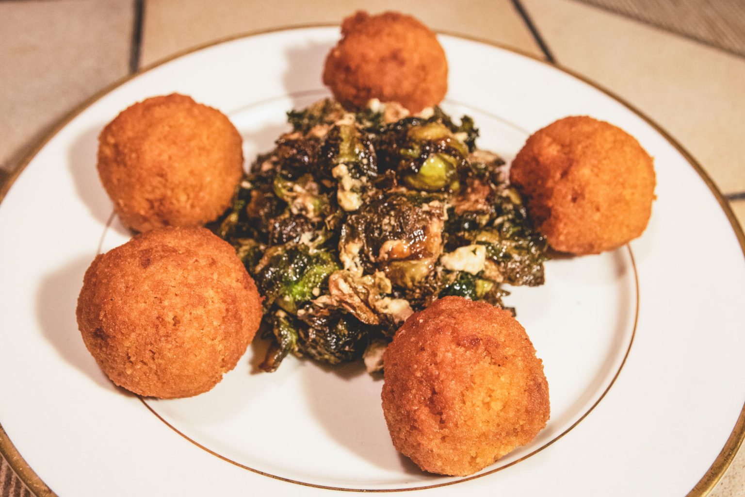 Falafels served delicately on a white plate.