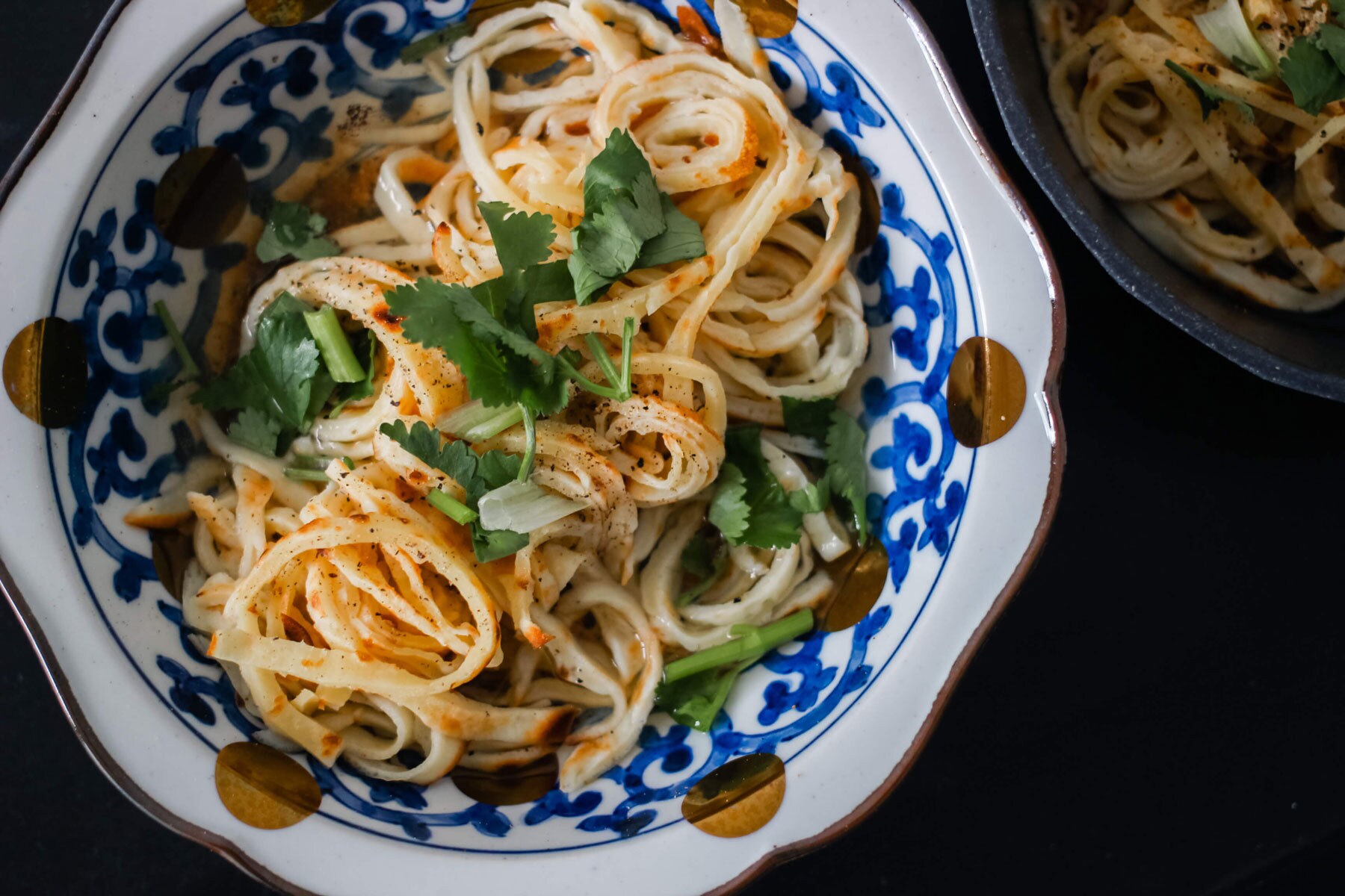 A bowl of crepe noodles in broth.