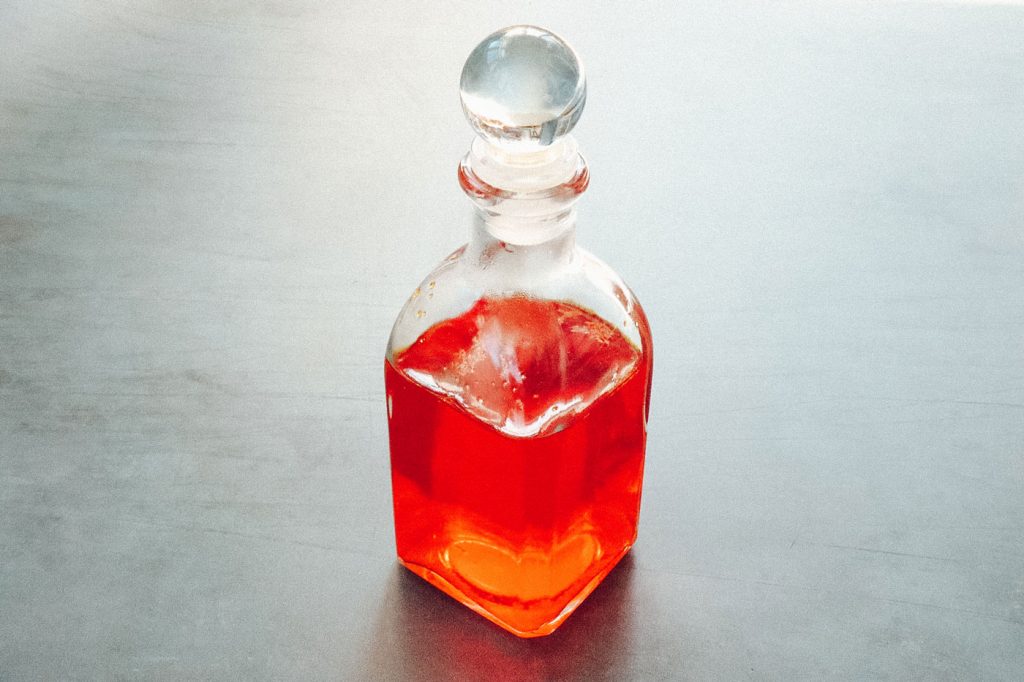 A small glass bottle holding Gold Water.