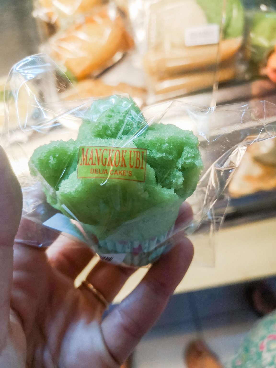 A green kue mangkok, a cupcake-like Indonesia dessert.