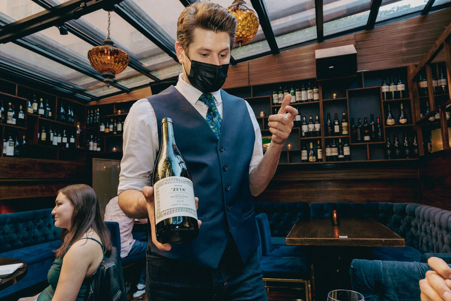 A server presenting a bottle.