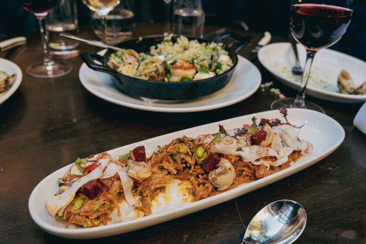 Two dishes served on a dining room table.