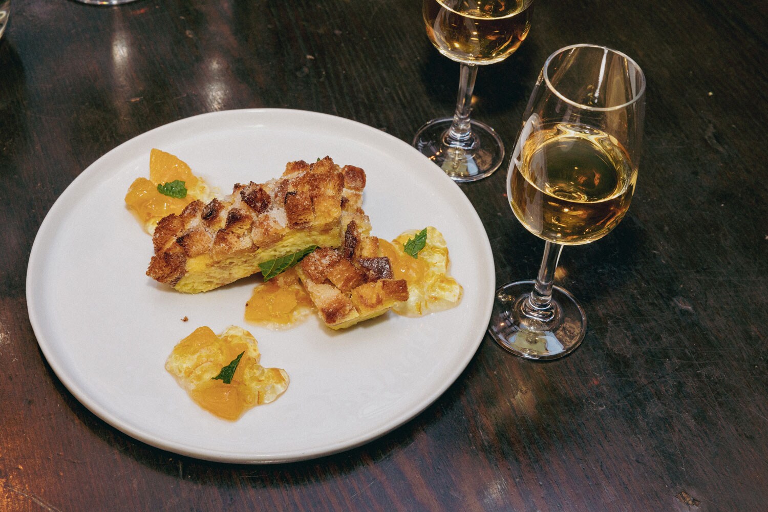 A dish served with two glasses of wine.