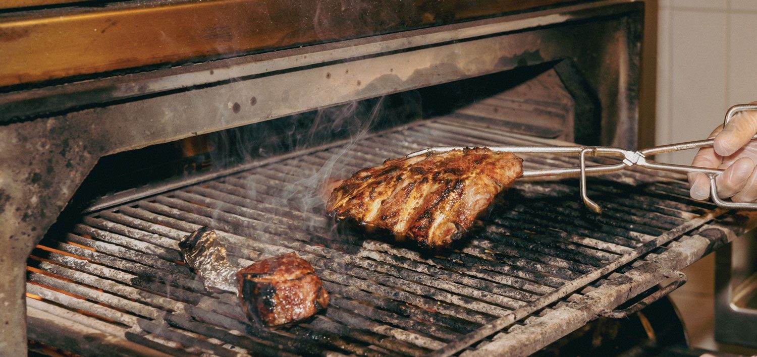 A piece of meat being grilled.