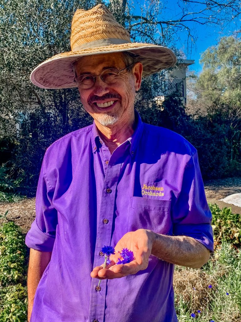 Peter Jacobsen holding delicate little flowers.