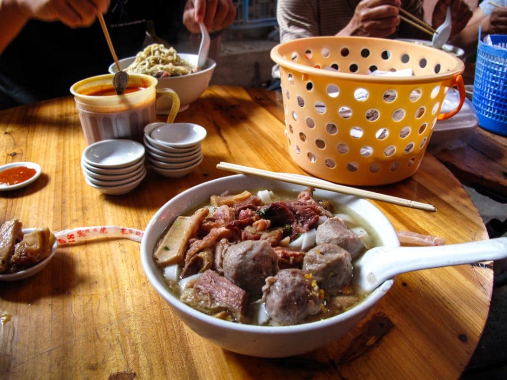 A bowl of soup on a table.