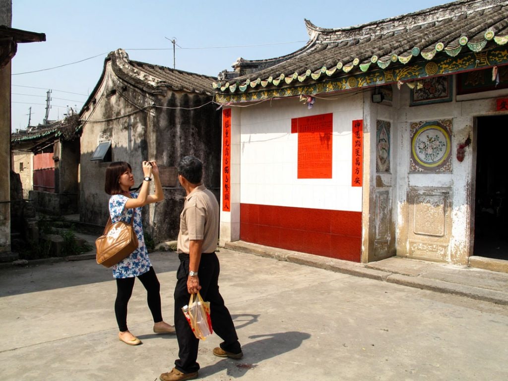 People taking pictures of the neighborhood.