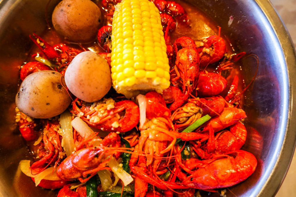 A crawfish boil with corn and potatoes.