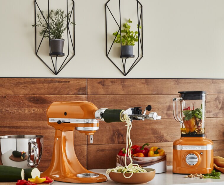 Stand Mixer in Honey spiralizing zucchini beside a matching blender