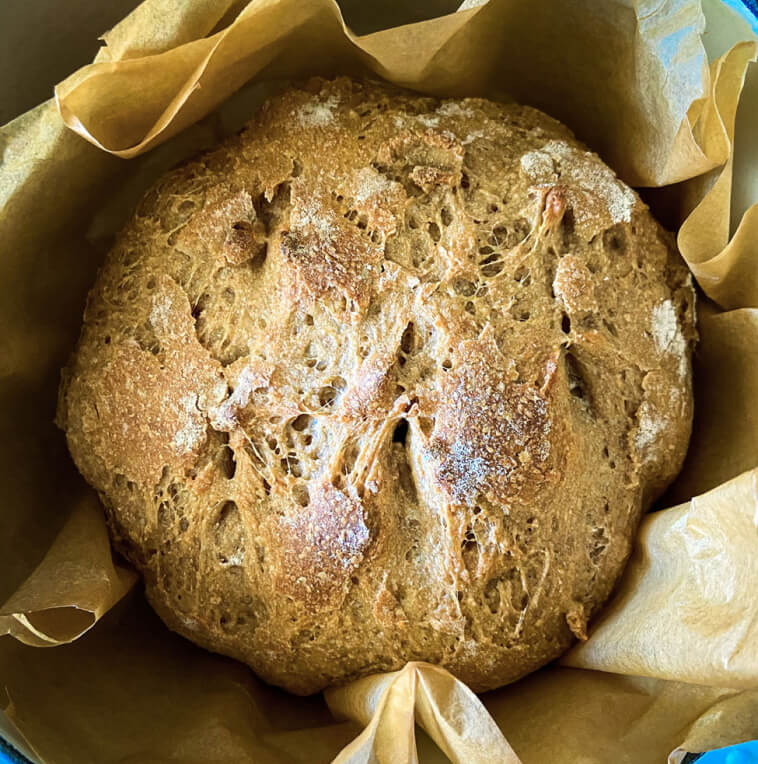  Overhead shot of loaf of baked crusty bread.