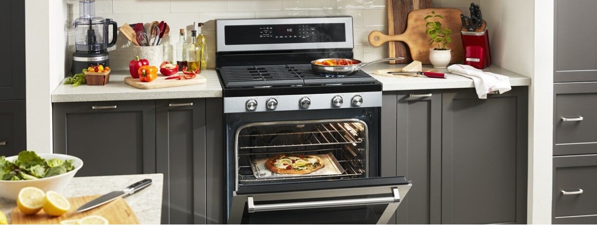 Grey cabinetry surrounding an open KitchenAid® Range