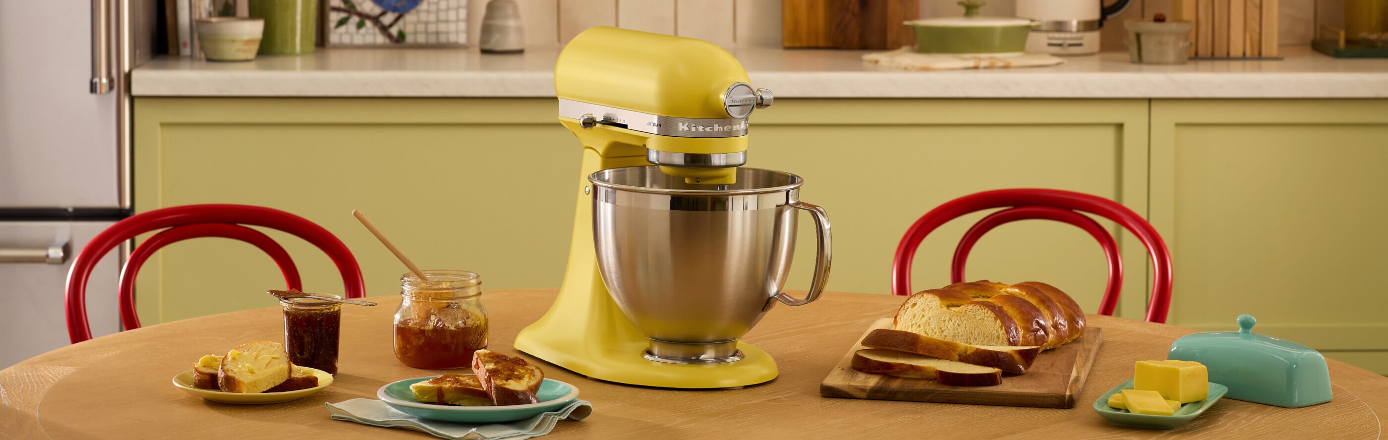 The Butter Stand Mixer surrounded by jams, breads and butter.