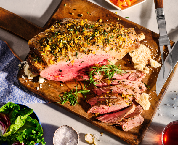 A medium-rare roast on a cutting board.