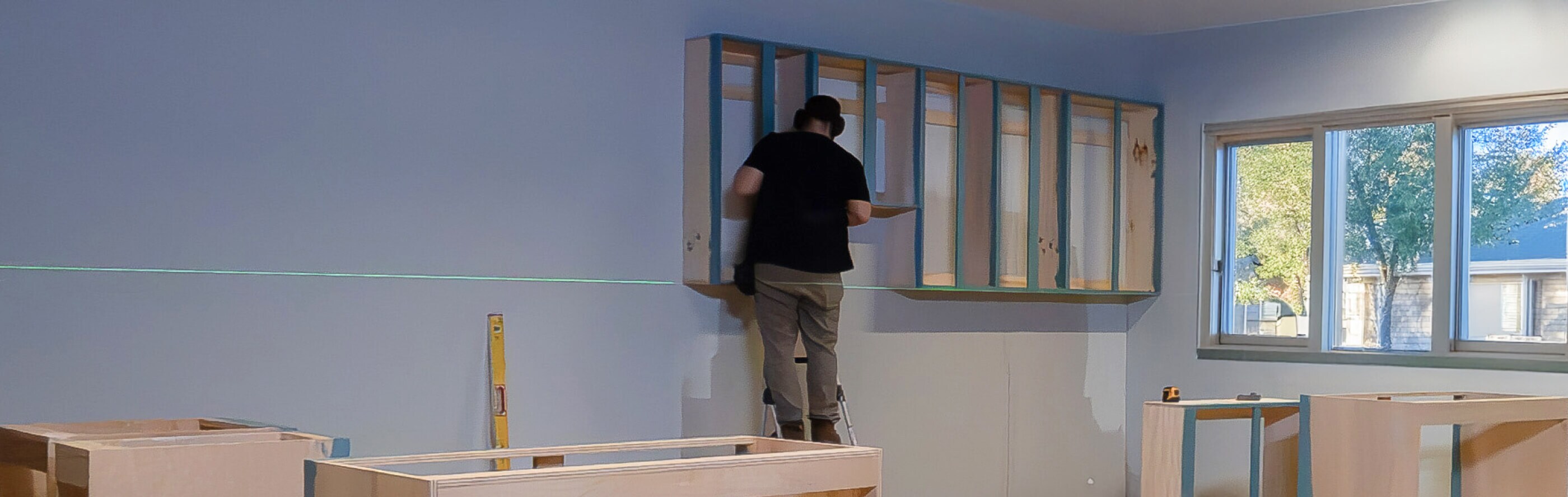 Person installing cabinetry