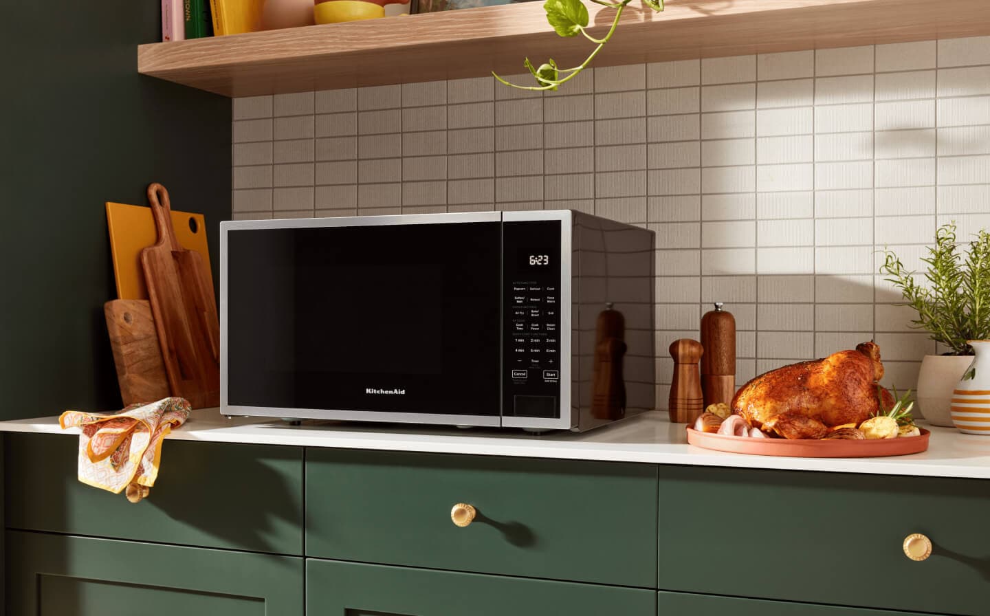 KitchenAid® countertop microwave on counter next to roasted chicken