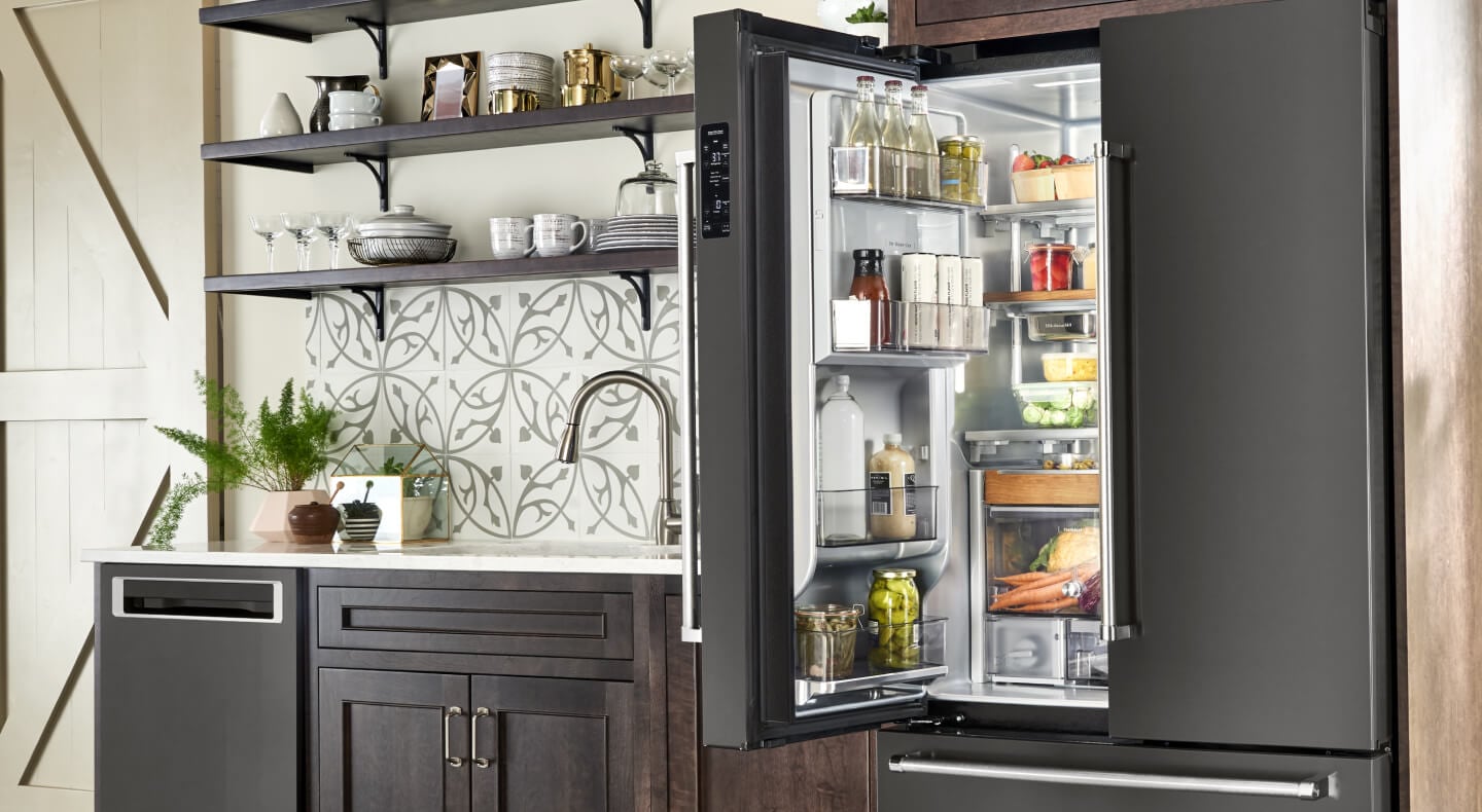 A kitchen with an open refrigerator in it
