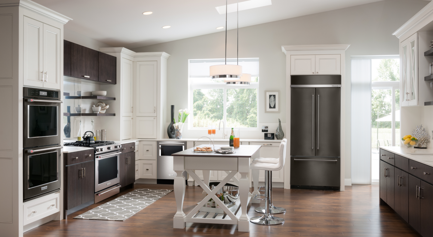 Open kitchen with a KitchenAid® double wall oven, gas range and built-in French-door refrigerator Open kitchen with a KitchenAid® double wall oven, gas range and built-in French-door refrigerator