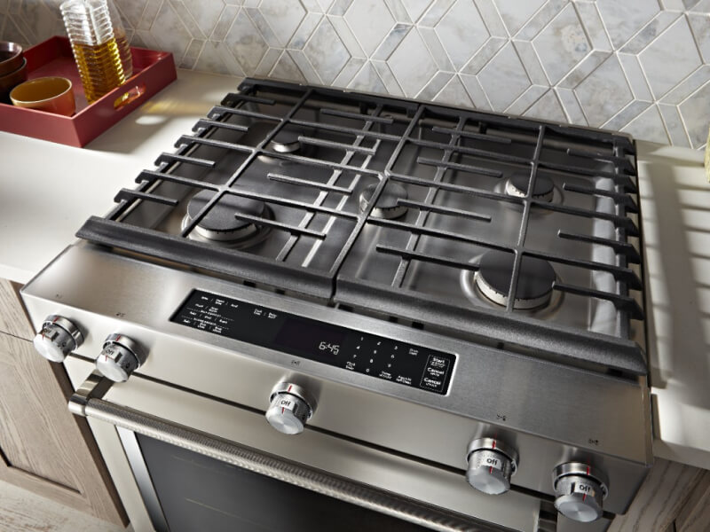 KitchenAid® gas range installed between white countertops