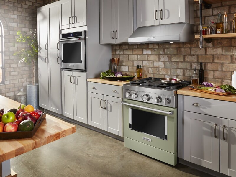 Colorful KitchenAid® commercial-style range in pale blue cabinetry