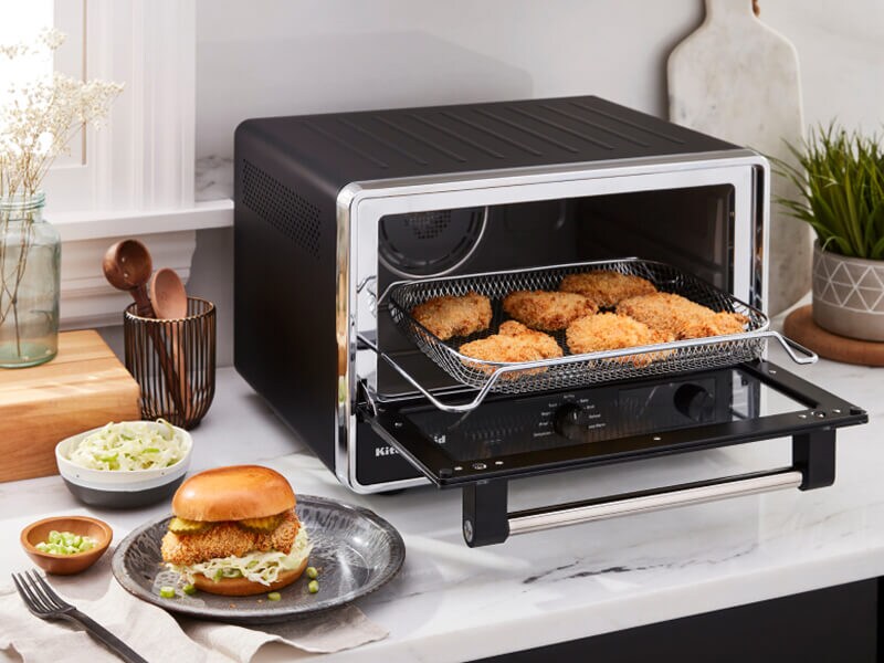 A KitchenAid® countertop oven preparing chicken patties for sandwiches A KitchenAid® countertop oven preparing chicken patties for sandwiches