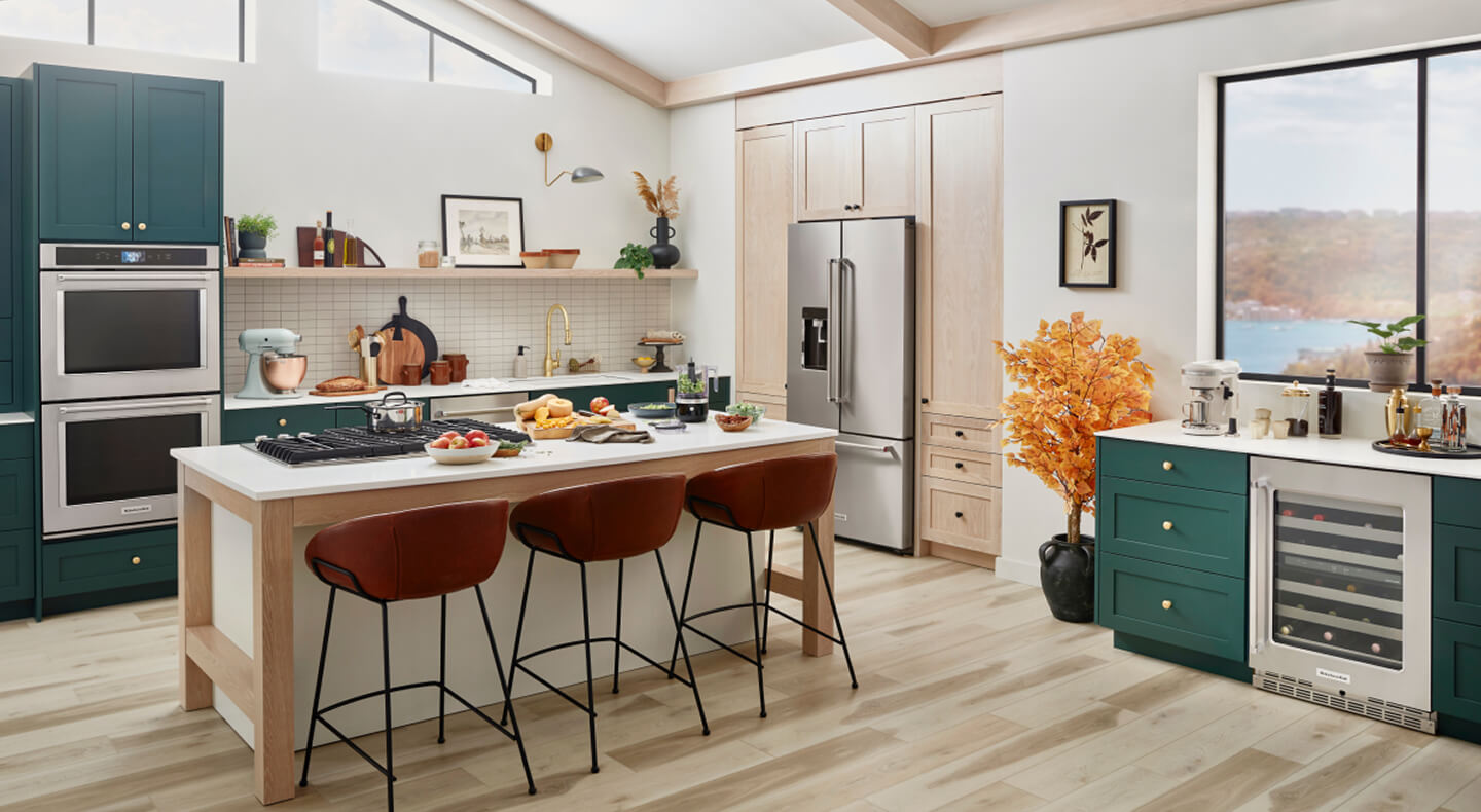 A trendy, stylish kitchen with teal cabinetry and a suite of KitchenAid® appliances A trendy, stylish kitchen with teal cabinetry and a suite of KitchenAid® appliances
