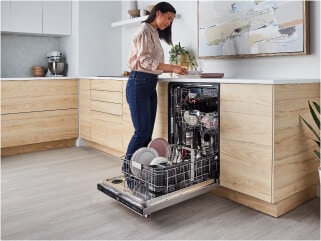 Person loading dishes into a dishwasher