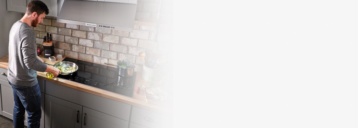 Person cooking on an electric cooktop